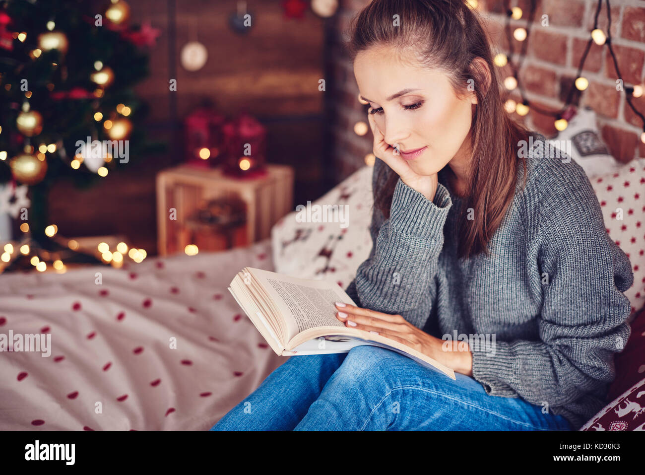 Woman reading a book in bedroom Stock Photo