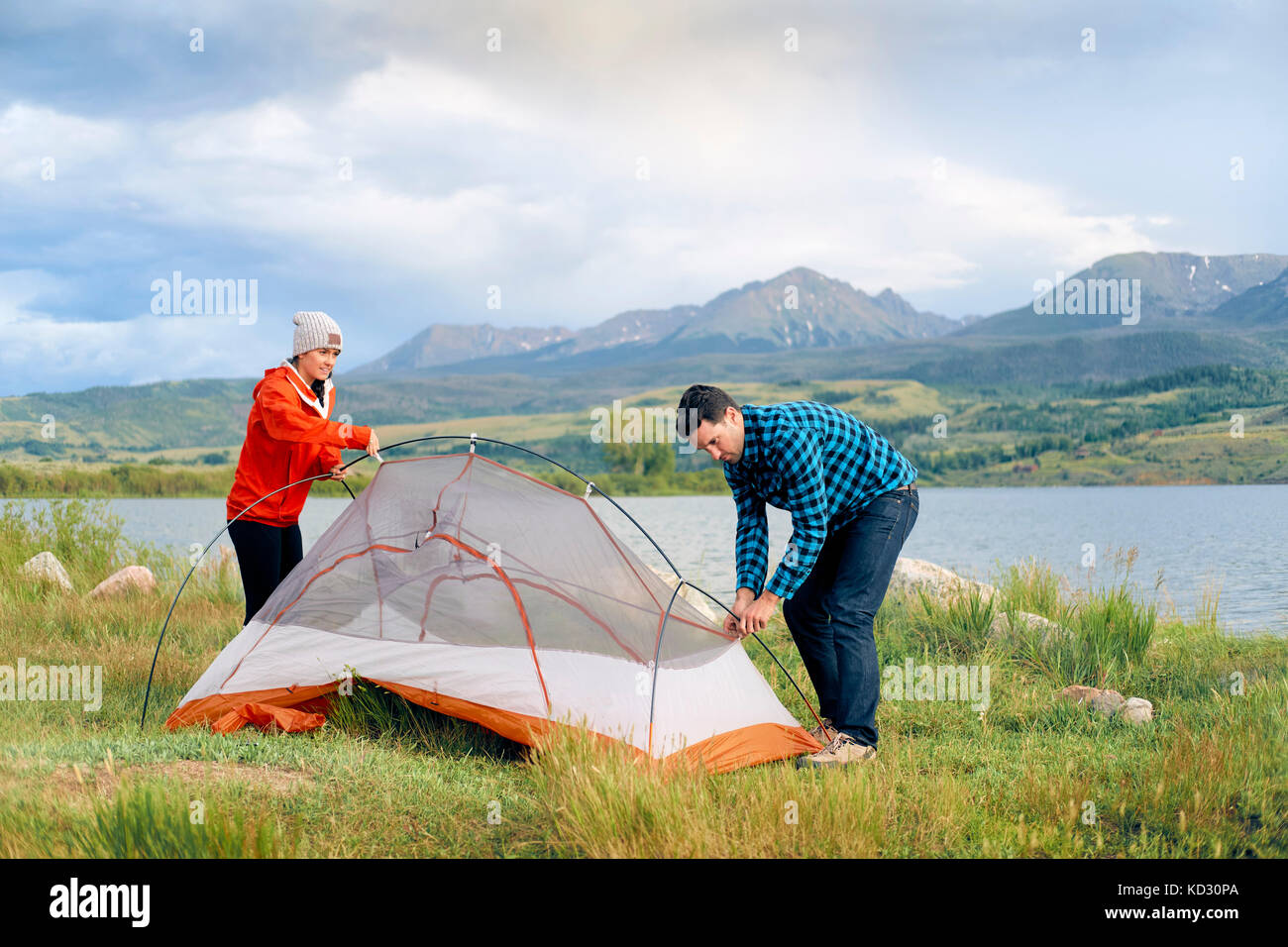Couple in rural setting, putting up tent, Heeney, Colorado, United States Stock Photo