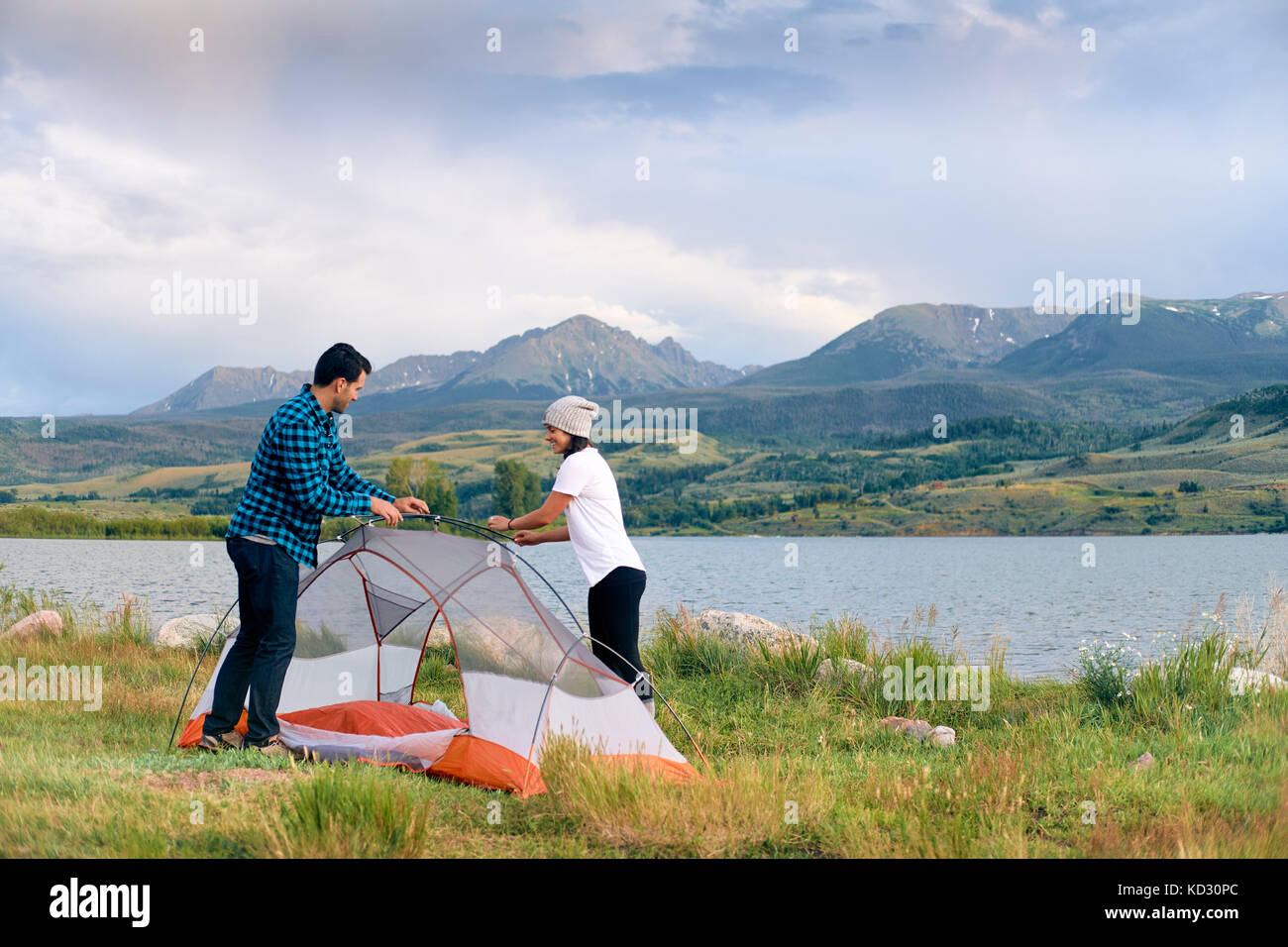 Couple in rural setting, putting up tent, Heeney, Colorado, United States Stock Photo