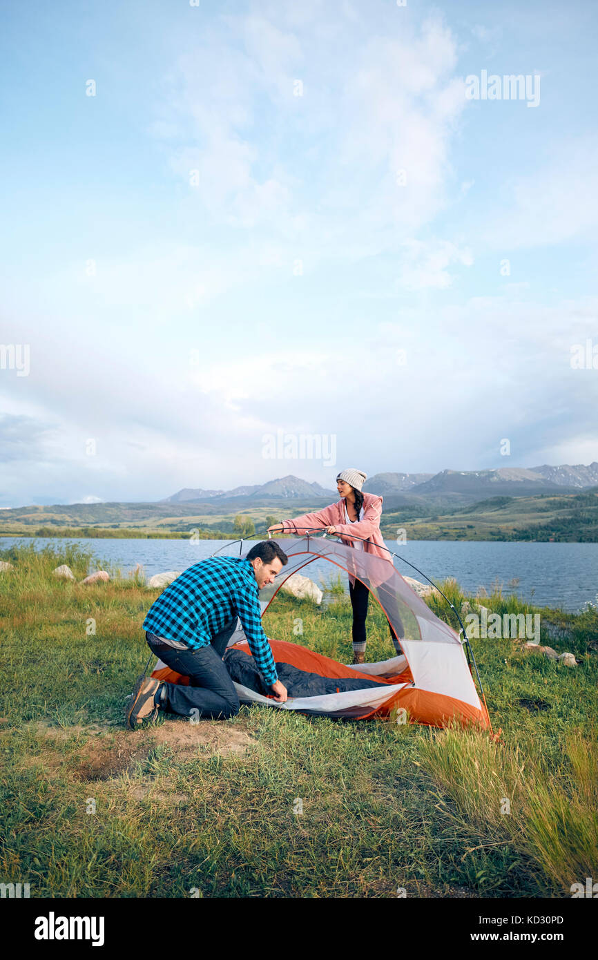 Couple in rural setting, putting up tent, Heeney, Colorado, United States Stock Photo