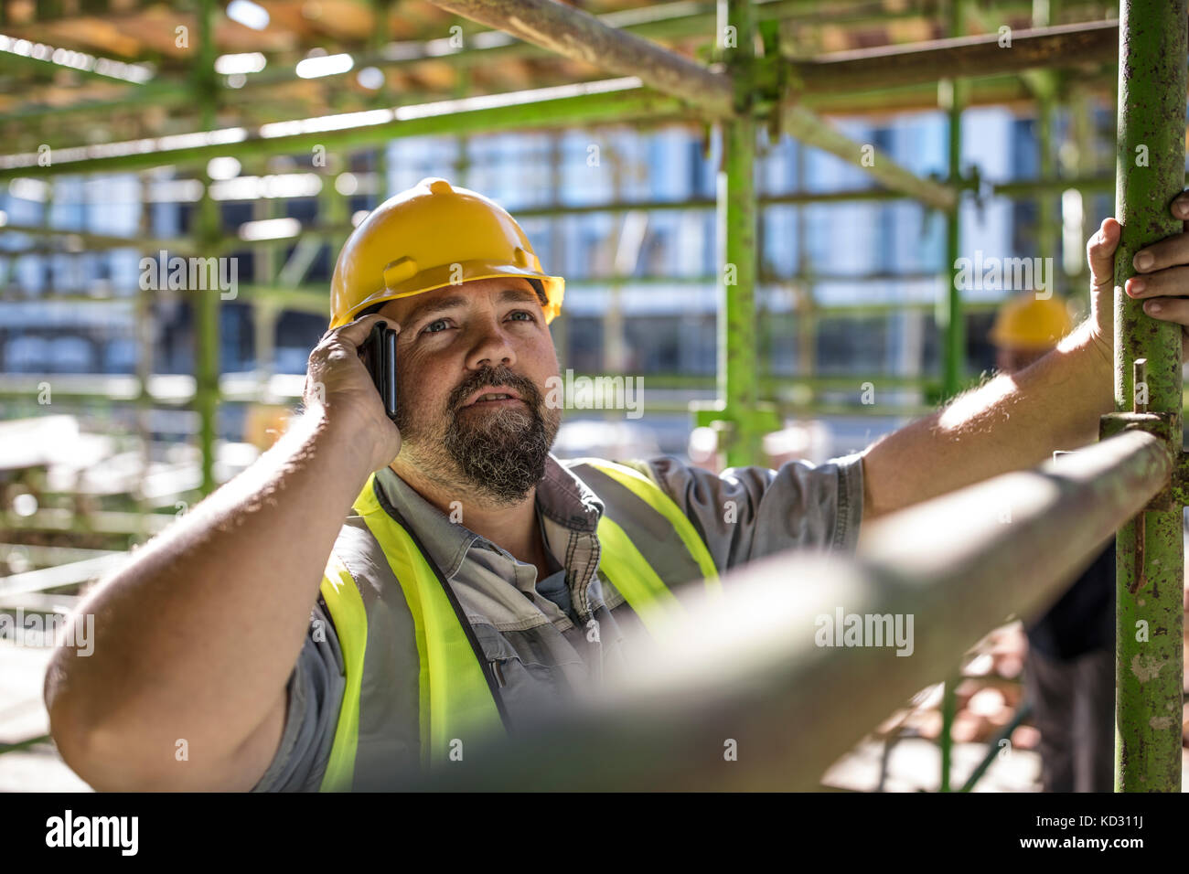Construction worker using mobile phone Stock Photo