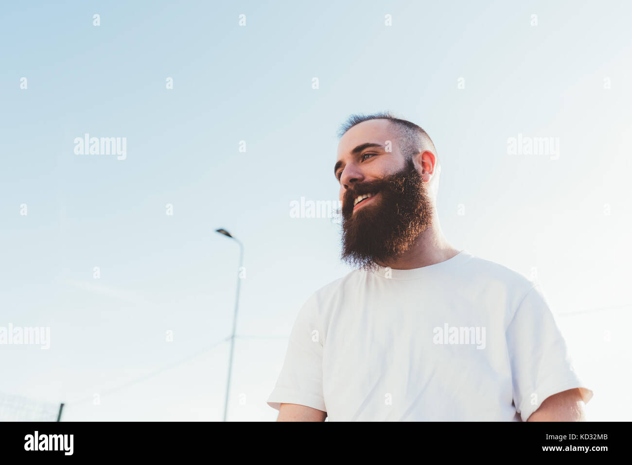 Portrait of bearded man looking away smiling Stock Photo