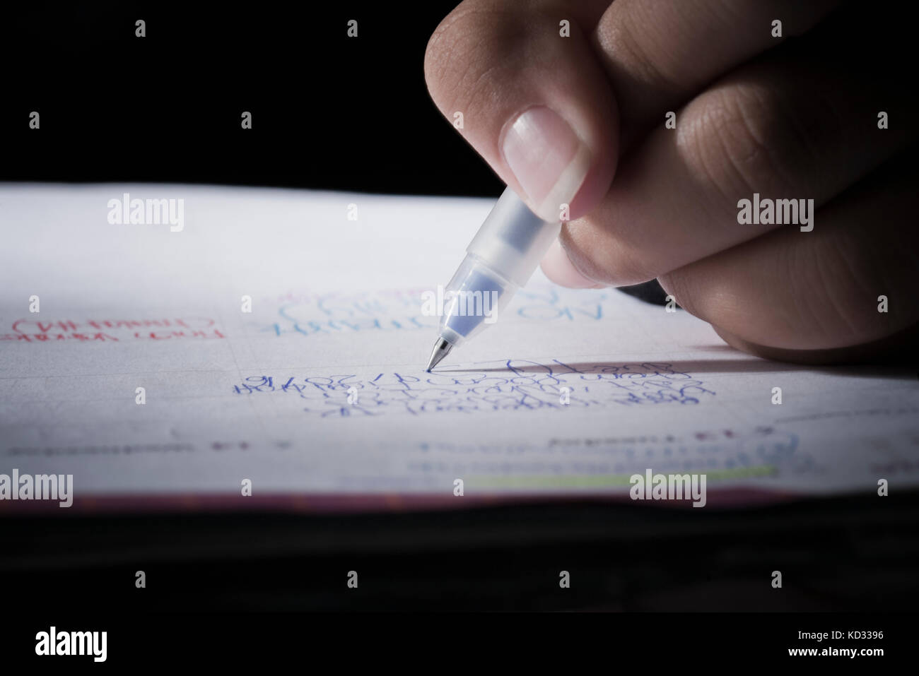Writing on notebook, black background Stock Photo