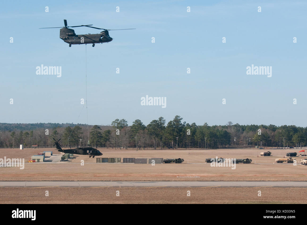 U.S. Soldiers from the S.C. Army National Guard work to prepare a UH-60 Black Hawk from Detachment 2, Company F, 1-171st General Support Aviation Battalion, S.C. Army National Guard, for sling-load movement to McEntire Joint National Guard Base, Eastover, S.C. Dec. 7, 2014. The Black Hawk made an emergency landing in an open field Dec. 3, 2014 due to a main rotor blade malfunction in Columbia, S.C. The Black Hawk was released by the Accident Review Board for recovery and was being transported via sling-load under a S.C. Army National Guard CH-47 Chinook helicopter from Detachment 1, B-Company, Stock Photo