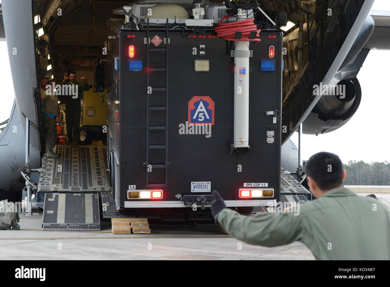 U.S. Air Force loadmasters assigned to the 14th Airlift Squadron at Joint Base Charleston, S.C., unload a U.S. Army North Task Force 51 radio communications vehicle off of a C-17 Globemaster III March 5, 2015, at McEntire Joint National Guard Base, S.C. Vigilant Guard is series of federally funded disaster-response drills conducted by National Guard units working with federal, state and local emergency management agencies and first responders. (U.S. Air National Guard photo by Airman 1st Class Ashleigh S. Pavelek/Released) Stock Photo