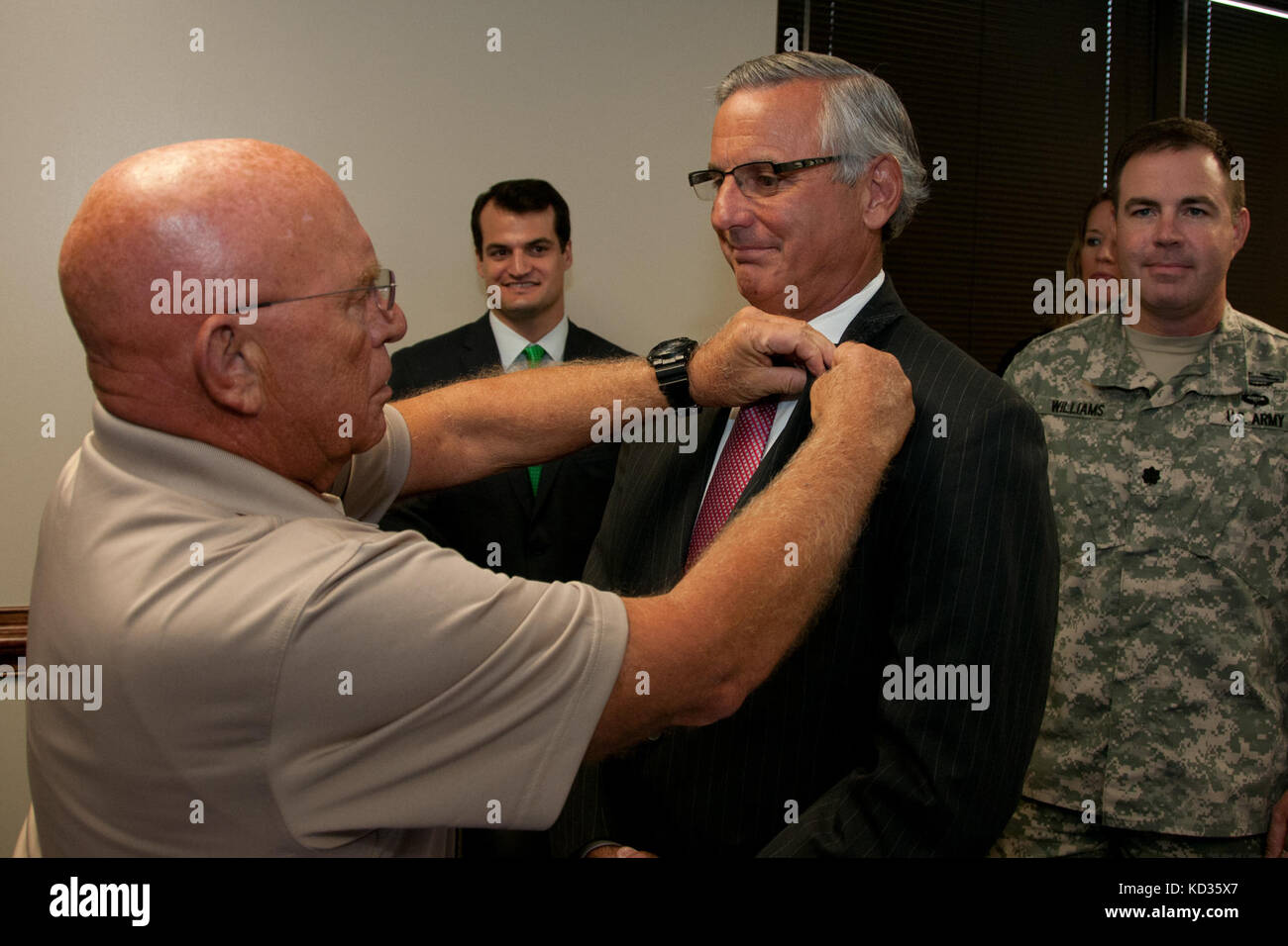 U.S. Army Maj. Gen. Robert E. Livingston, Jr., the adjutant general for South Carolina, presents the South Carolina Employer Support of Guard and Reserve Patriot Award to Mr. Will McMaster of Morgan Stanley at the Joint Force Headquarters building, South Carolina National Guard, Columbia, South Carolina, Aug. 27, 2015. The Patriot award is awarded to individual supervisors who demonstrate exceptional support to National Guard Citizen Soldiers and Airmen who perform their duties to the state and nation. During the event, an ESGR statement of support was signed demonstrating the company’s contin Stock Photo
