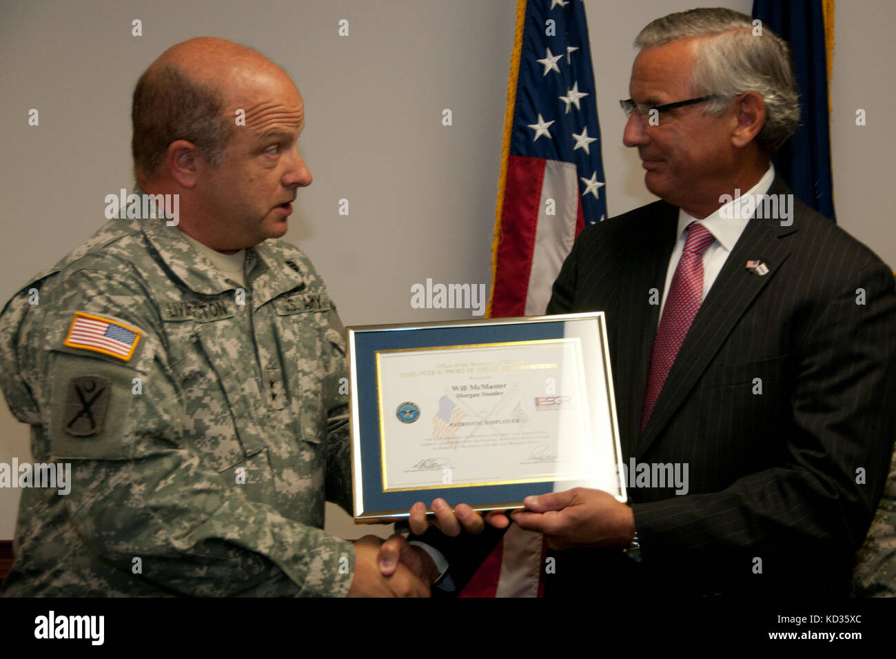 U.S. Army Maj. Gen. Robert E. Livingston, Jr., the adjutant general for South Carolina, presents the South Carolina Employer Support of Guard and Reserve Patriot Award to Mr. Will McMaster of Morgan Stanley at the Joint Force Headquarters building, South Carolina National Guard, Columbia, South Carolina, Aug. 27, 2015. The Patriot award is awarded to individual supervisors who demonstrate exceptional support to National Guard Citizen Soldiers and Airmen who perform their duties to the state and nation. During the event, an ESGR statement of support was signed demonstrating the company’s contin Stock Photo