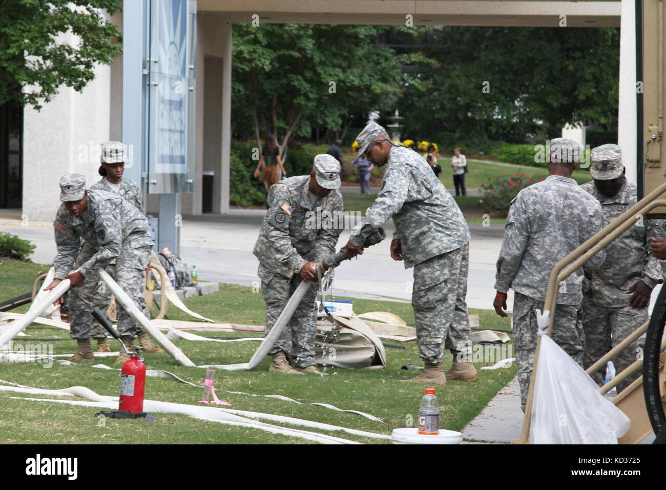 S.C. National Guard Soldiers from the 741st Quartermaster Battalion drag hoses around the grounds of Richland Memorial Hospital that will connect to water treatment equipment, Oct 8. The 741st Quartermaster Battalion and 218th Brigade Support Battalion worked together to purify water for the hospital since most of Columbia was under a boil-water advisory. Guardsmen have been assisting in a variety of ways throughout the state after the worst rains and flooding in recorded history. The S.C. National Guard was on call before the storms hit and continued to provide support to the state’s citizens Stock Photo