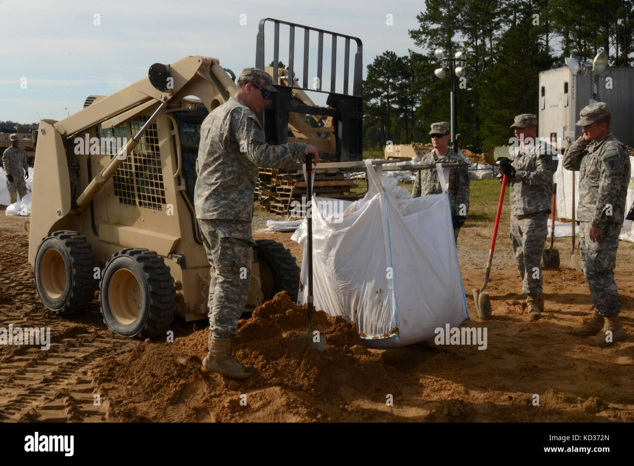 U.S. Army Soldiers from the South Carolina National Guard fill sand bags at McCrady Training Center, S.C., during a statewide flood response, Oct. 9, 2015. The South Carolina National Guard has been activated to support state and county emergency management agencies and local first responders as historic flooding impacts counties statewide. Currently, more than 2,600 South Carolina National Guard members have been activated in response to the floods. (U.S. Air National Guard photo by Airman Megan Floyd/Released) Stock Photo