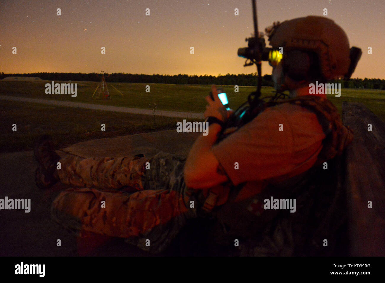 A U.S. Air Force Joint Terminal Attack Controller assigned to the 22nd Special Tactics Squadron looks through his night vision as he conducts close air support operations at Poinsett Electronic Combat Range on Shaw Air Force Base, S.C., May 21, 2014.  Elements of the South Carolina Army and Air National Guard, U.S. Army and U.S. Air Force special operations, and Columbia Police Department S.W.A.T., conducted nighttime training, which allowed special operations forces and the National Guard to conduct joint urban assault training. (U.S. Air National Guard photo by Tech. Sgt. Jorge Intriago/Rele Stock Photo