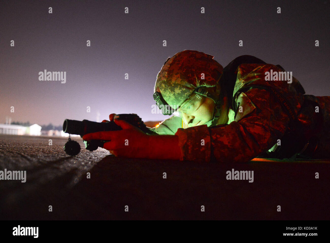 U.S. Army Sgt. Brian Calhoun assigned to the 108th Public Affairs Detachment, takes photos using night vision mounted camera at McEntire Joint National Guard Base, S.C., May 20, 2014.  Elements of the South Carolina Army and Air National Guard, U.S. Army and U.S. Air Force special operations, and Columbia Police Department S.W.A.T., conduct urban assault training, which allowed special operations forces and National Guard assets to work alongside each other while training in an urban environment.  (U.S. Air National Guard photo by Tech. Sgt. Jorge Intriago/Released) Stock Photo