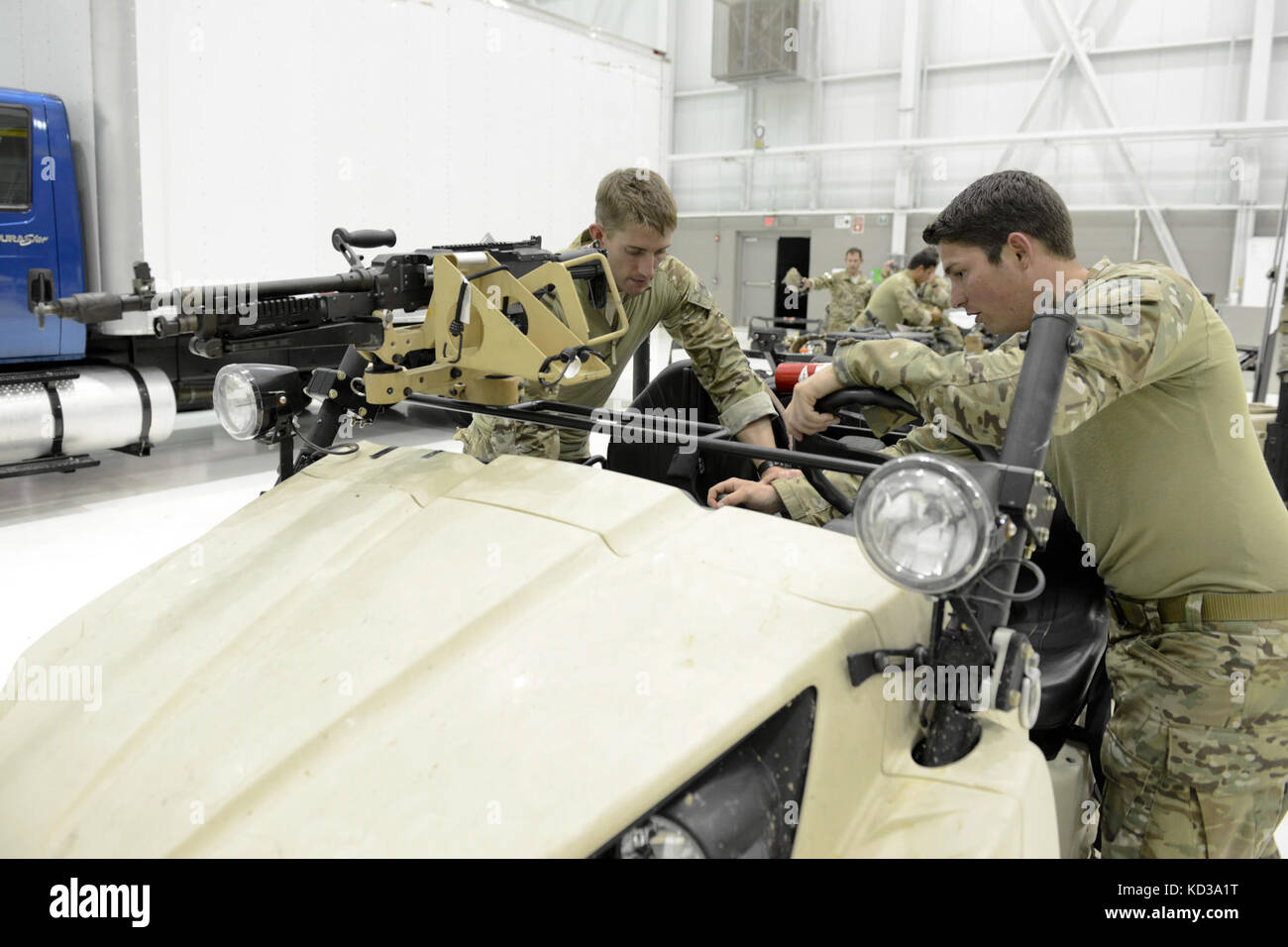 U.S. Air Force Capt. Josh Kitchen, left, assigned to the 169th Fighter Wing, is shown a Lightweight All Terrain Vehicle by a U.S. Army Special Forces Soldier at McEntire Joint National Guard Base, S.C., May 20, 2014.  Elements of the South Carolina Army and Air National Guard, U.S. Army and U.S. Air Force special operations, and Columbia Police Department S.W.A.T., conduct urban assault training, which allowed special operations forces and National Guard assets to work alongside each other while training in an urban environment.  (U.S. Air National Guard photo by Tech. Sgt. Jorge Intriago/Rele Stock Photo