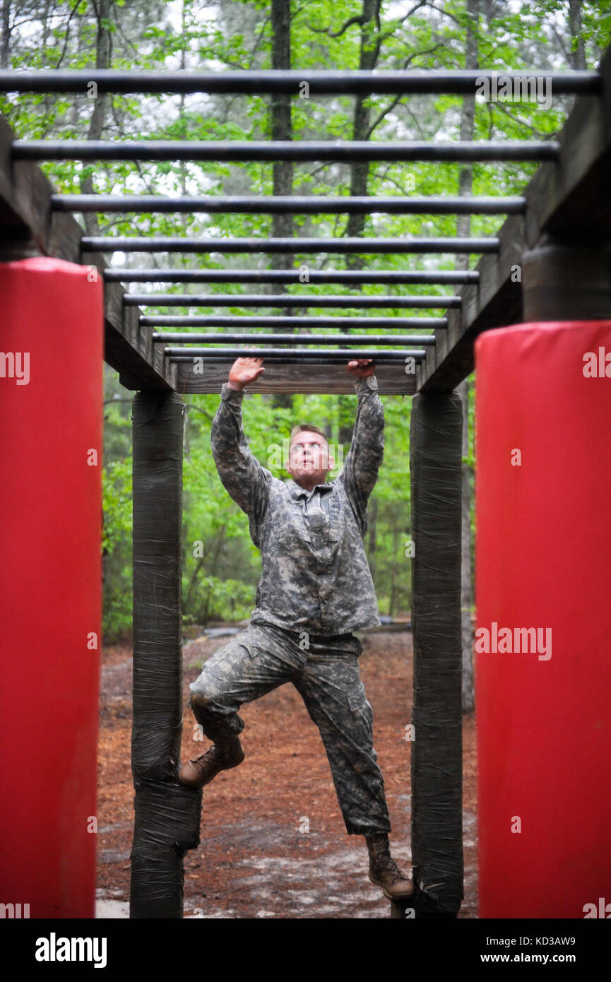 U.S. Army Staff Sgt. Scott Tinney, 202 EOD, Georgia Army National Guard, demonstrates his skills in obstacle navigation, strength and endurance while completing the Fit to Win obstacle course on Fort Jackson during the Region 3 Best Warrior Competition at the McCrady Training Center, Eastover, S.C., April 30, 2013. Each of the 10 states and territories in Region 3 have one Soldier and one noncommissioned officer competing in the four day event which will test their Soldiering skills, April 29 to May 2. The first-place winners in the NCO and enlisted Soldiers categories will advance to the Nati Stock Photo