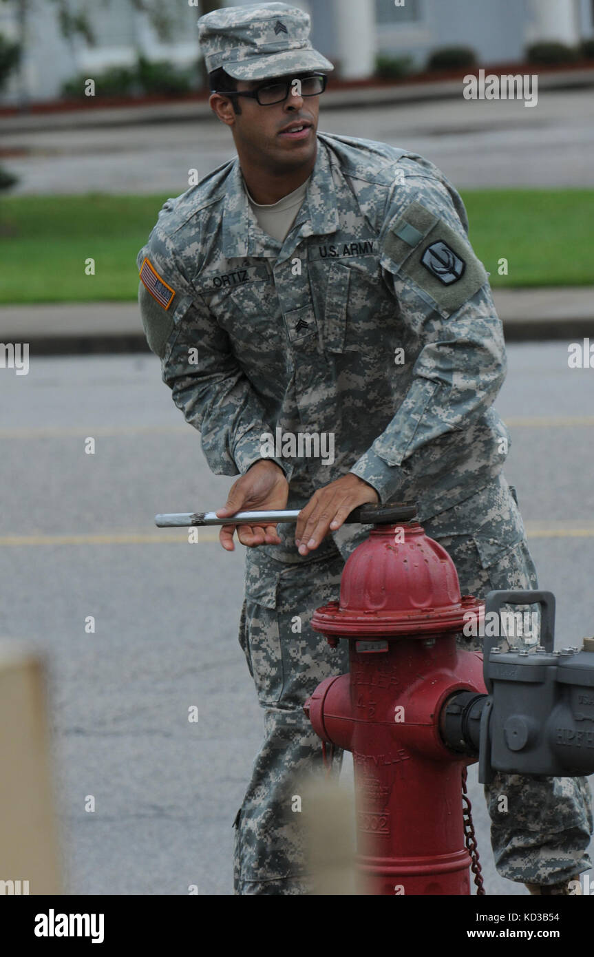 U.S. Army Sgt. Jerry Ortiz, 1052nd Transportation Company, opens a fire hydrant to fill potable water containers, during flood relief operations in Kingstree, S.C., Oct. 5, 2015. (Photo by South Carolina Army National Guard Sgt. Joshua S. Edwards.) Stock Photo