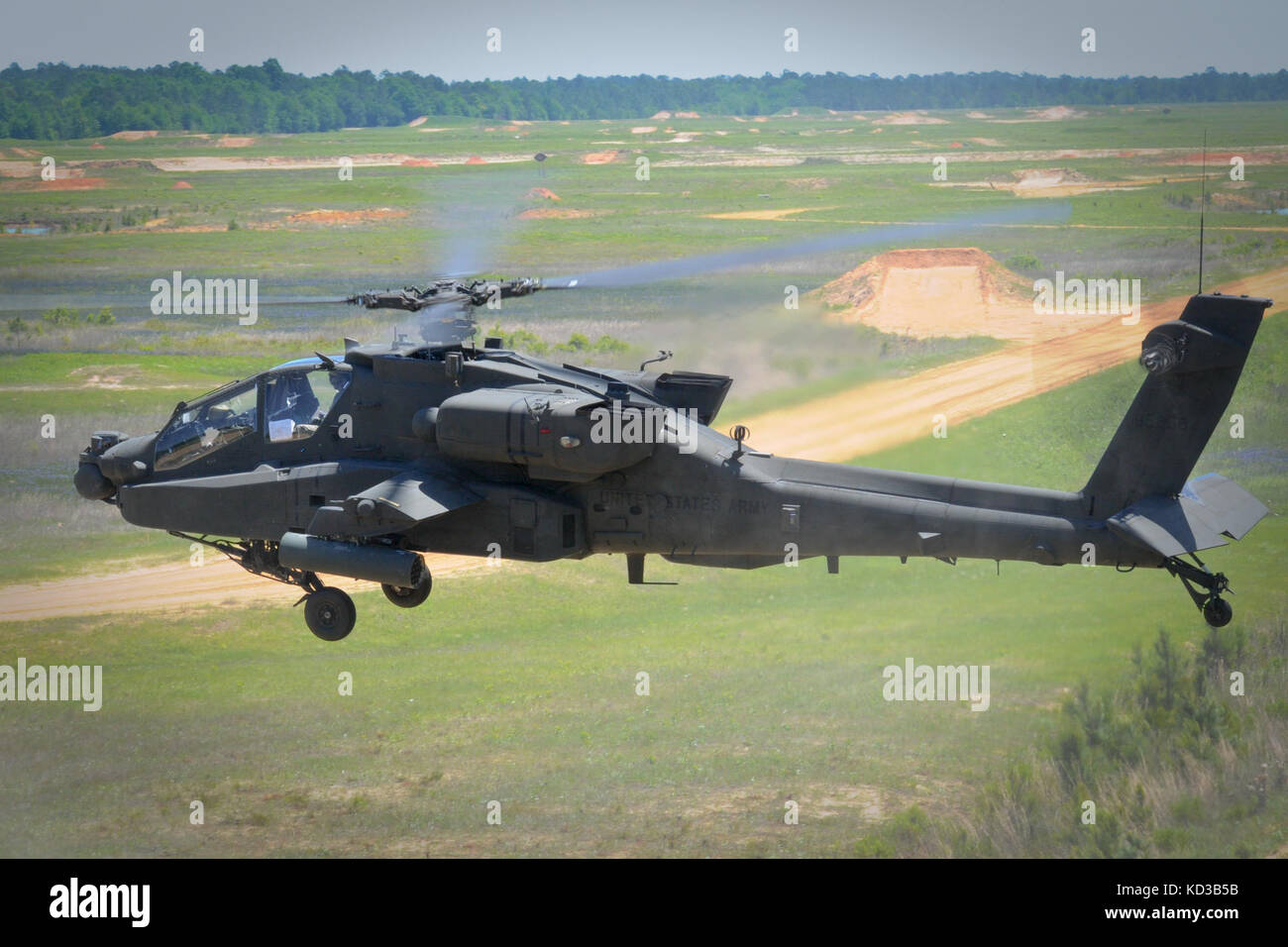 A U.S. Army AH-64D Apache assigned to S.C. Army National Guard’s 1/151 Attack Reconnaissance Battalion enters the range at Ft. Stewart, Ga., on May 4, 2014, to begin gunnery exercises as part of the unit’s annual training. Crews were tested with a variety of scenarios where they fired 30mm ammunition and point detonation rockets. (U.S. Army National Guard photo by. Sgt. Brian Calhoun/Released) Stock Photo