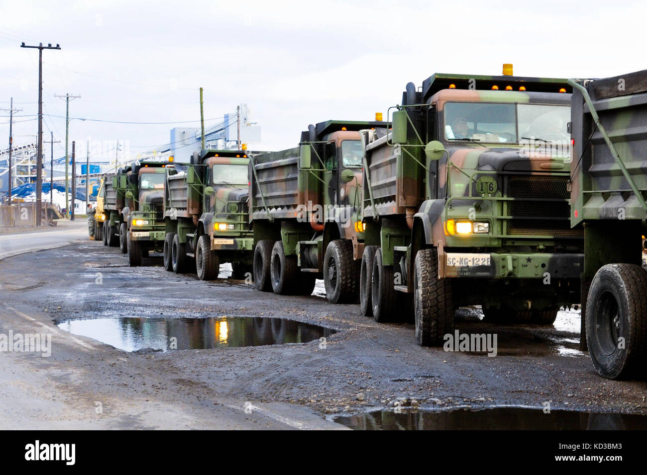 Thirty South Carolina Army National guard dump trucks support hauling operations in response to a request by the S. C Department of Transportation to transport 600 tons of road salt from the Charleston sea salt plant to Columbia, following  the ice storm that impacted the state Feb 11-12.  More than 180 Soldiers were put on state active duty to respond to the winter storm following the declaration of state of emergency by Gov. Nikki Haley Feb, 11, 2014.(U.S. Army National Guard photo by Sgt. Brian Calhoun) Stock Photo