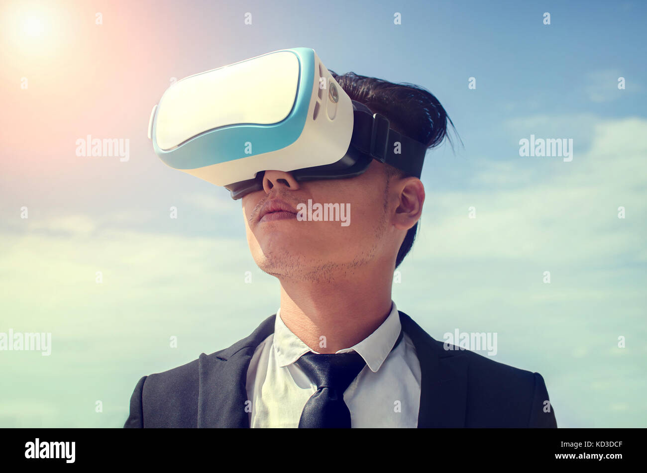 Businessman wearing virtual reality glasses . Mixed media Stock Photo