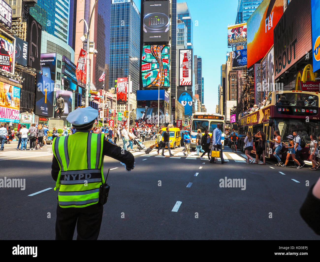 The policeman directs the traffic at the intersection in Time Square on Manhattan Stock Photo