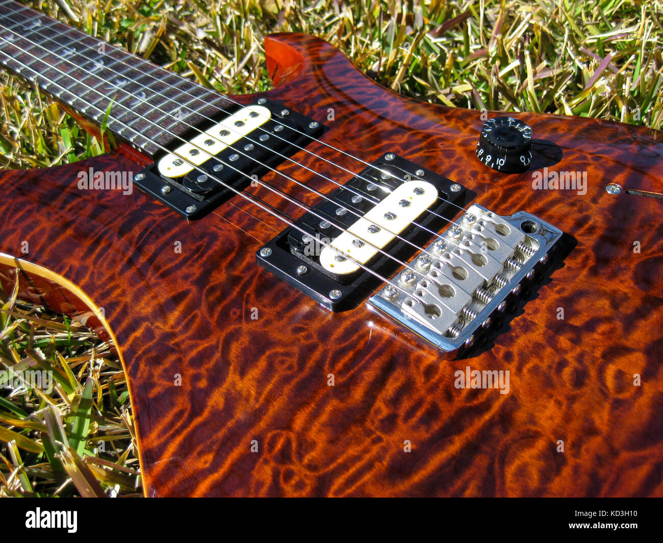 PRS Quilted maple brown guitar glowing in the afternoon sun. Stock Photo