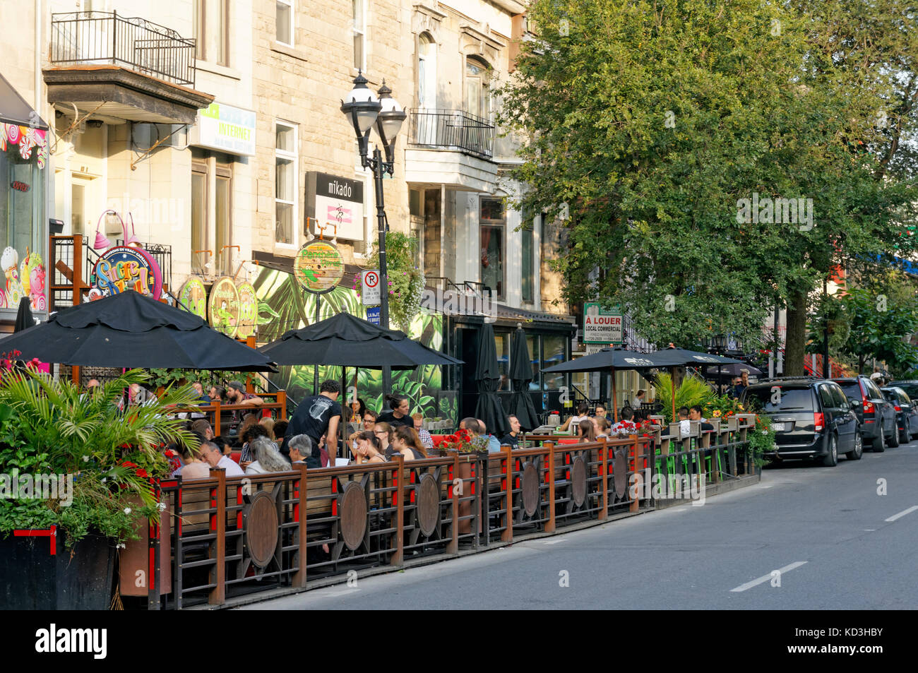 People sitting and talking in outdoor restaurants and bistros on Rue