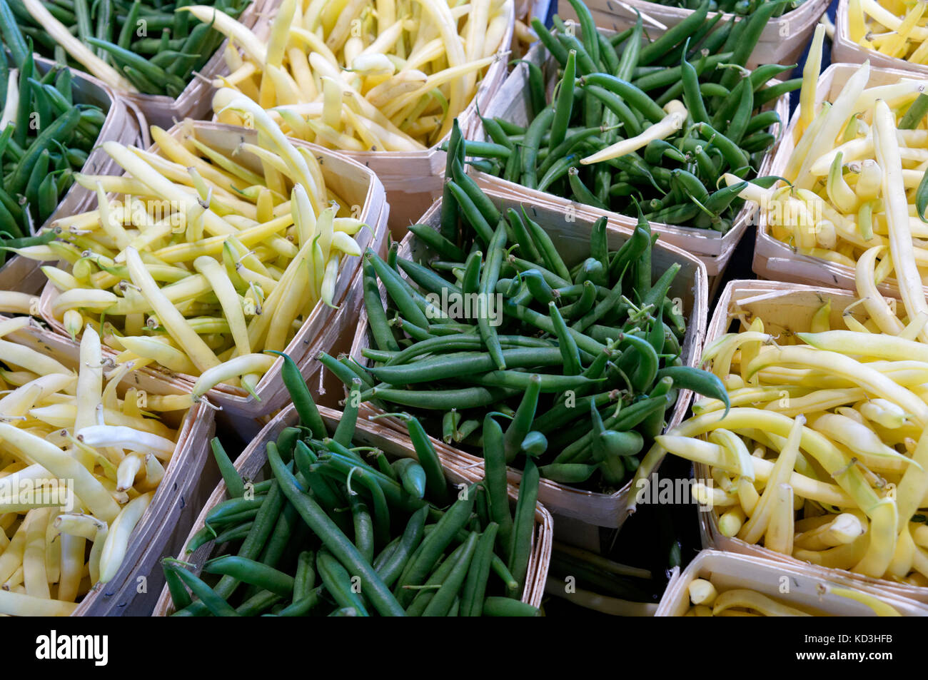 Containers of wax beans and green beans for sale in the Jean Talon public market or Marche Jean Talon, Montreal, Quebec, Canada Stock Photo