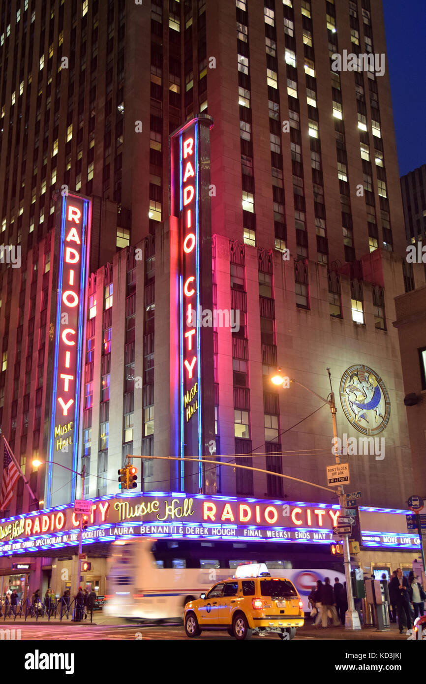 NEW YORK - APRIL 27: Night traffic sppeds past landmark Radio City Music Hall in New York City on April 27, 2015. The venue is legendary in entertainm Stock Photo