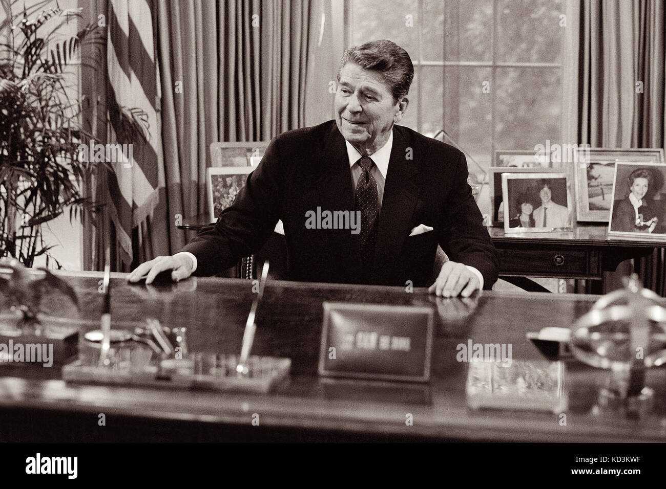 President Ronald Reagan at his desk in the White House Oval Office. Stock Photo