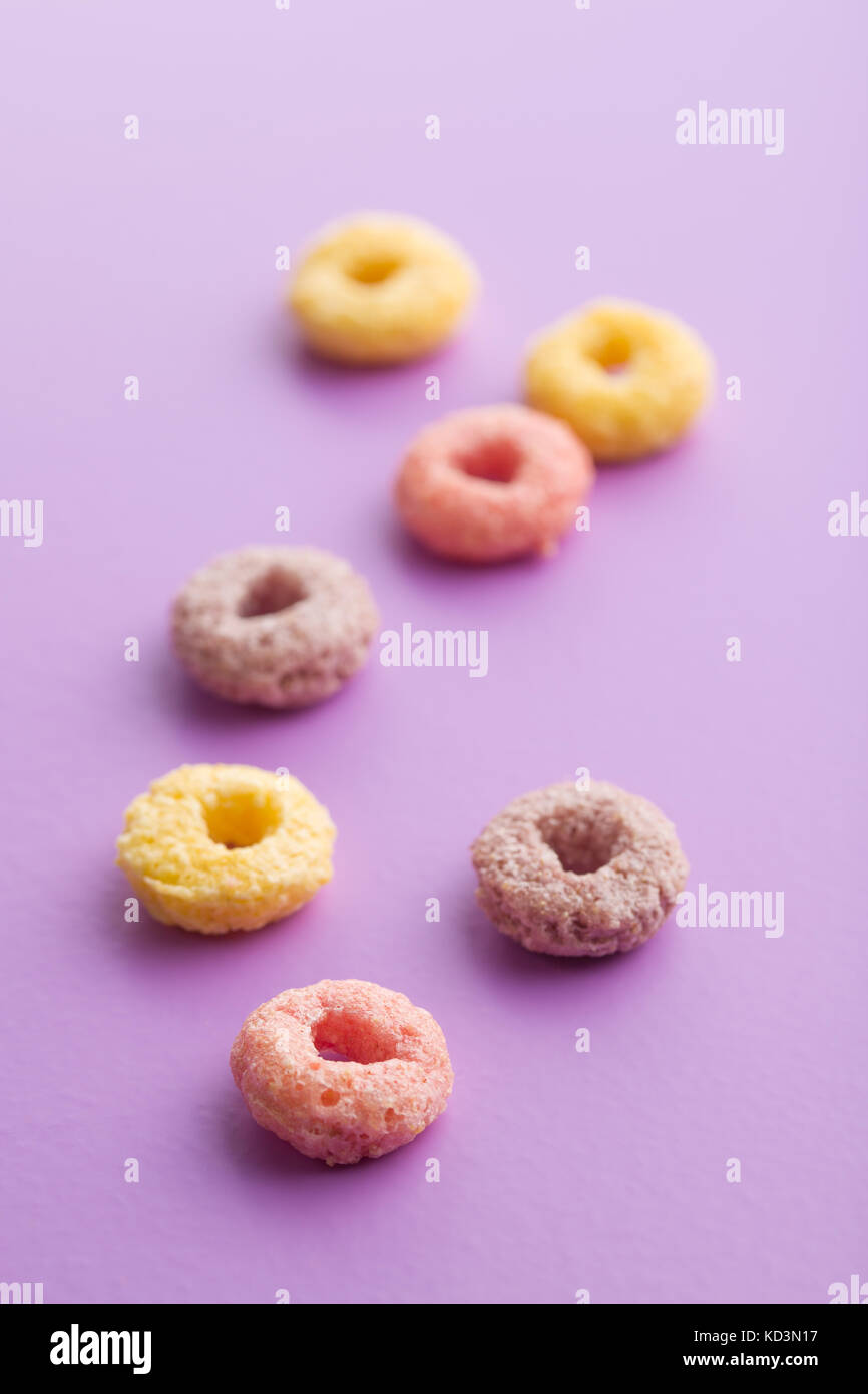 Colorful cereal rings on colorful background. Stock Photo