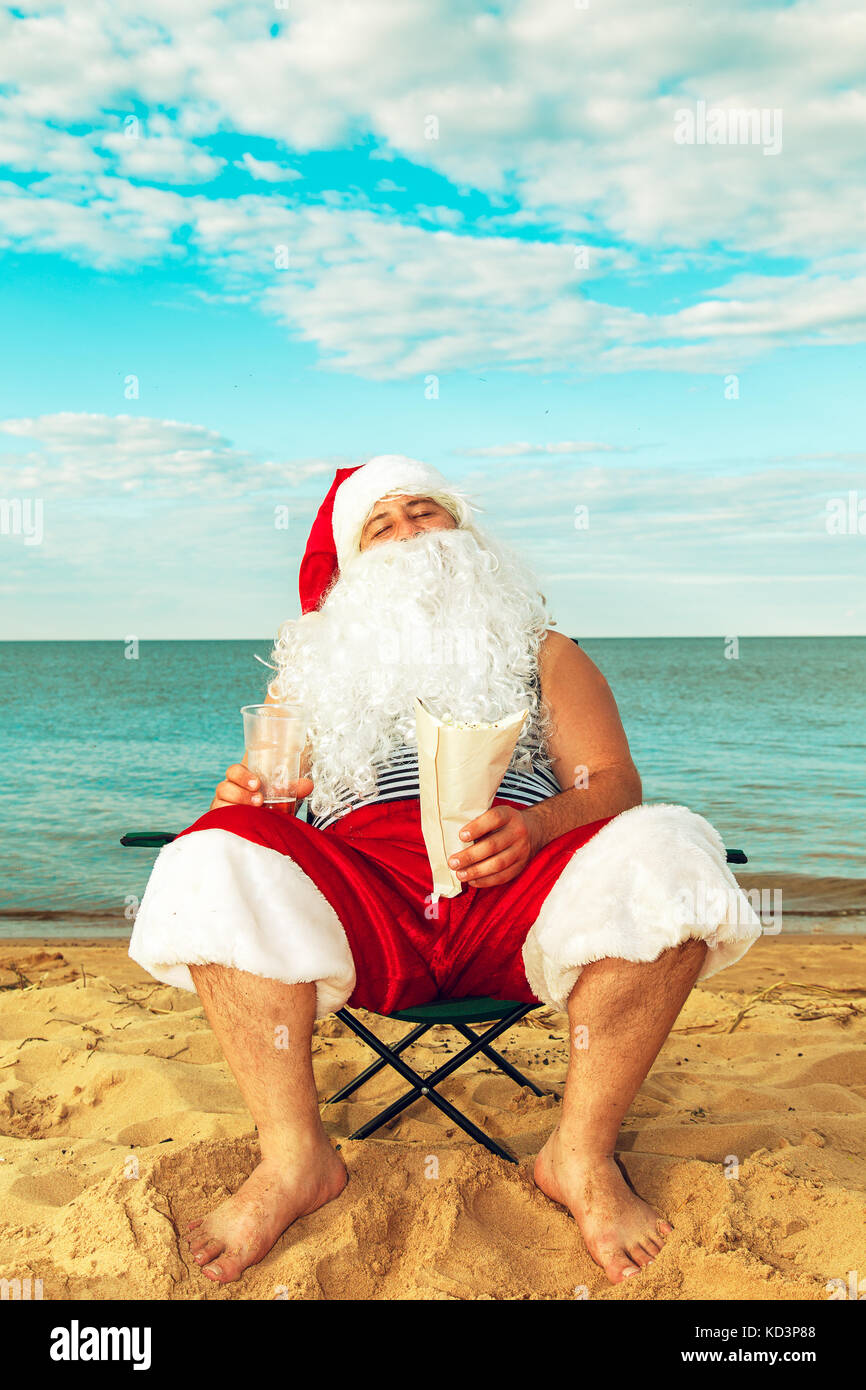 Santa Claus is sitting on the beach. The symbol of Christmas Stock ...