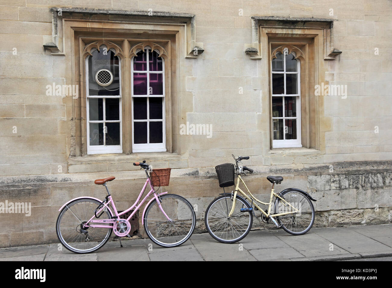 Ladies bicycles propped against wall of college building, Oxford, UK Stock Photo