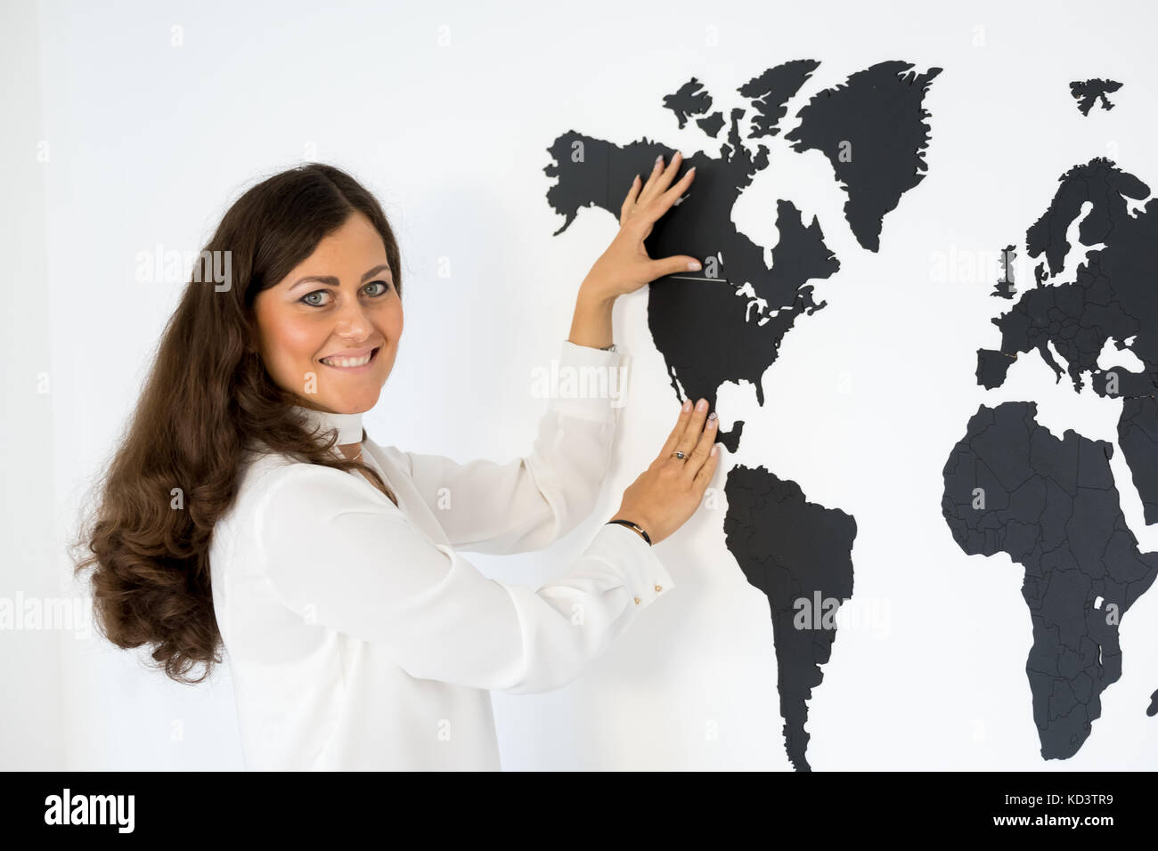 Couple is fixing the world map Stock Photo - Alamy