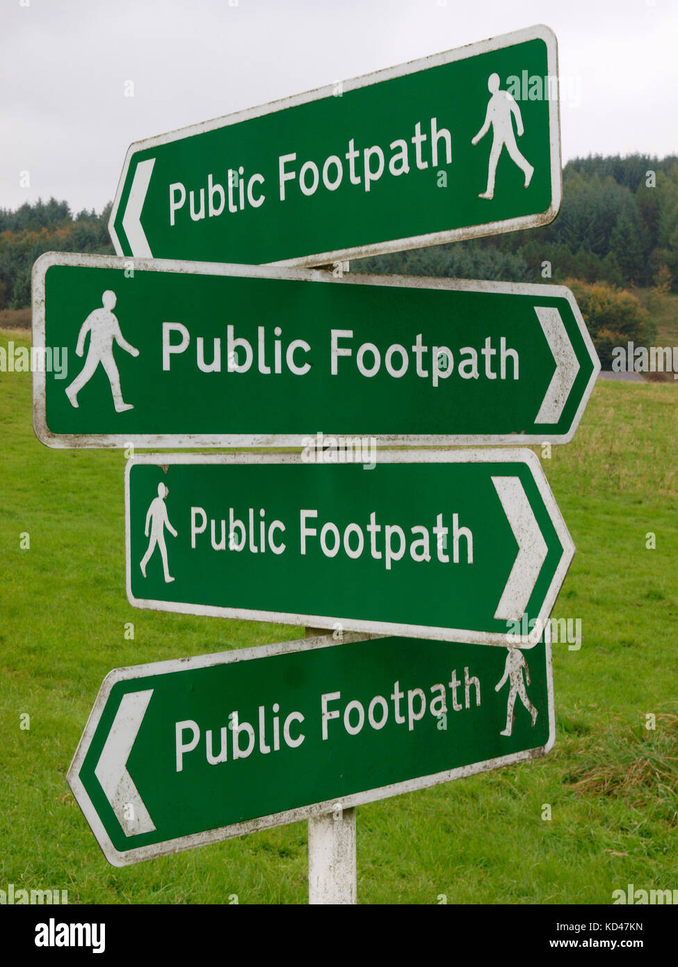 Four public footpath signs pointing in different directions on the same pole, Buxton, The Peak District, Derbyshire, UK Stock Photo