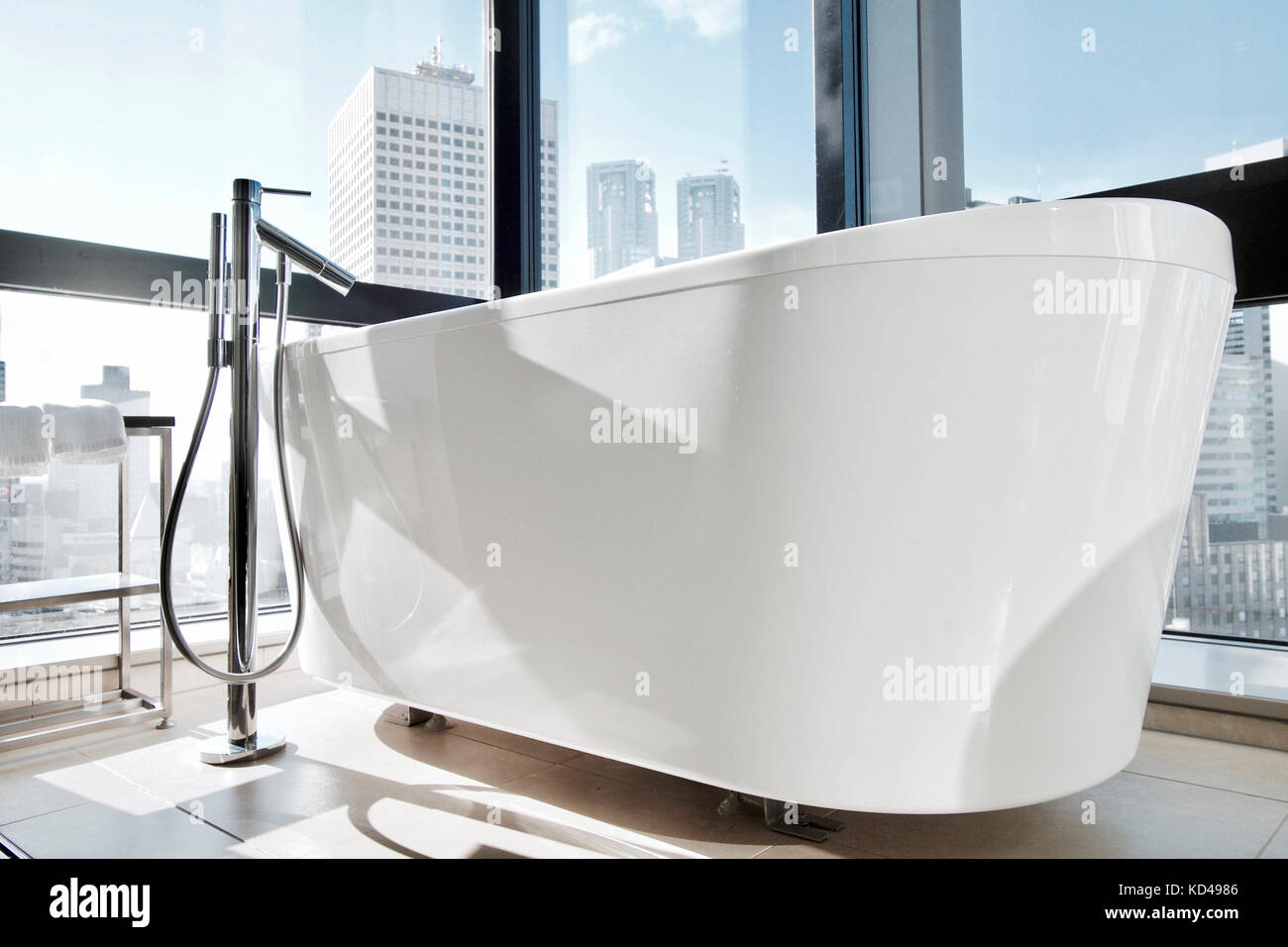 A freestanding Bathtub at a hotel in Japan with clear view of the buildings at Shinjuku Stock Photo