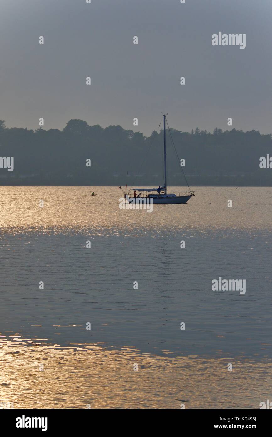 Isolated image of a lake and boat on sunset Stock Photo - Alamy