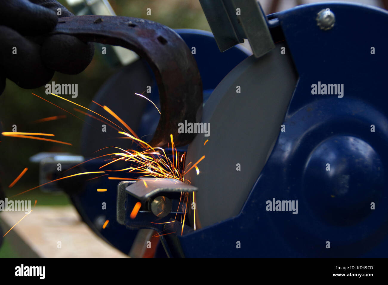 Electric wheel grinding with light sparks and gleam. Industry theme background. Stock Photo