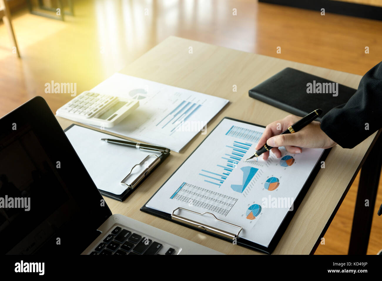 businessman working on paper to proof for market plan Stock Photo