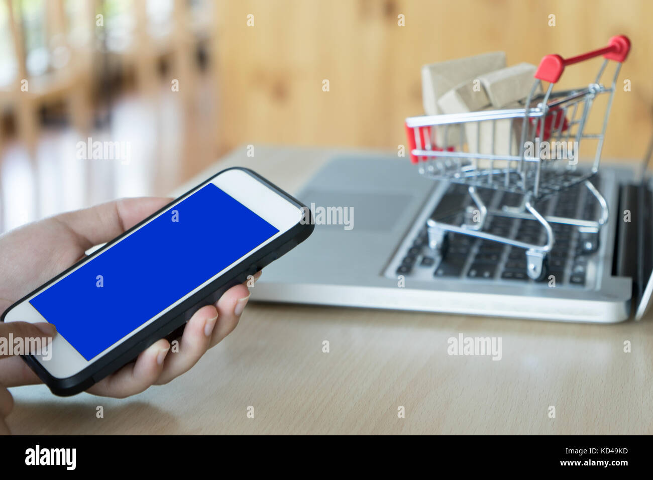for concept shopping online a customer use mobile phone and computer and model Cart with mobile phone screen clipping path Stock Photo