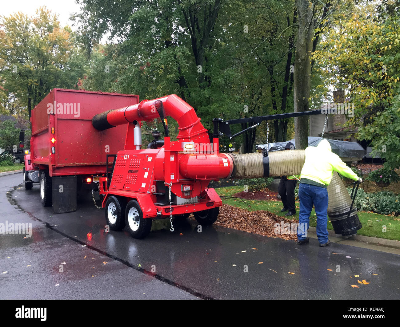 Autumn clean up of leafs with vacuum truck. Stock Photo