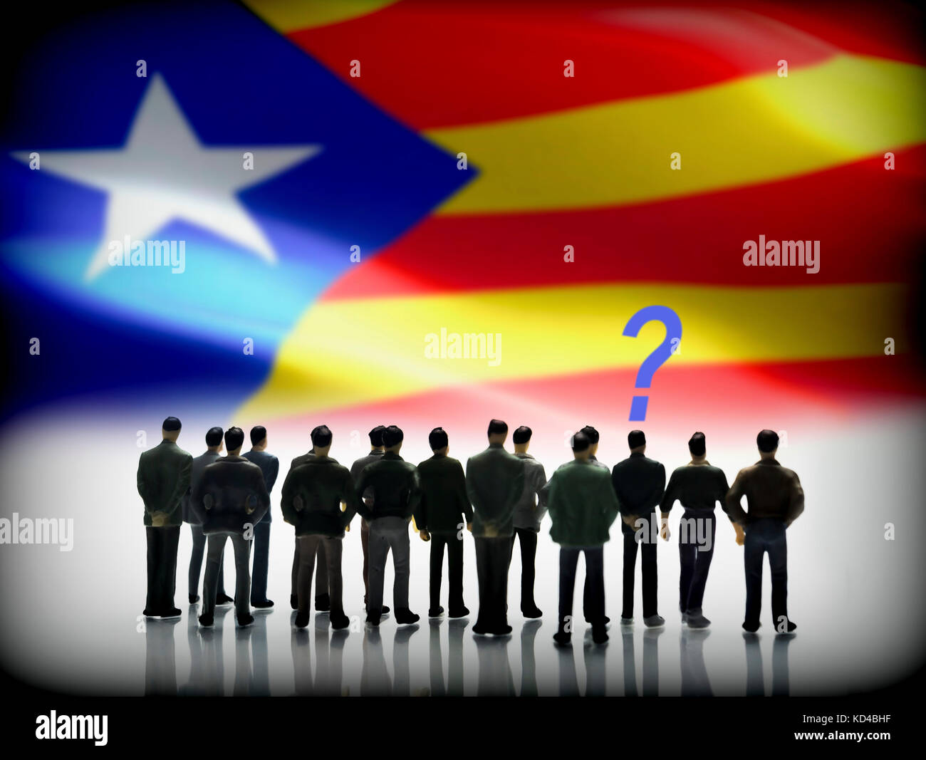 Silhouettes of figures of undecided persons in front of a flag independence of catalonia, digital composition, conceptual image Stock Photo