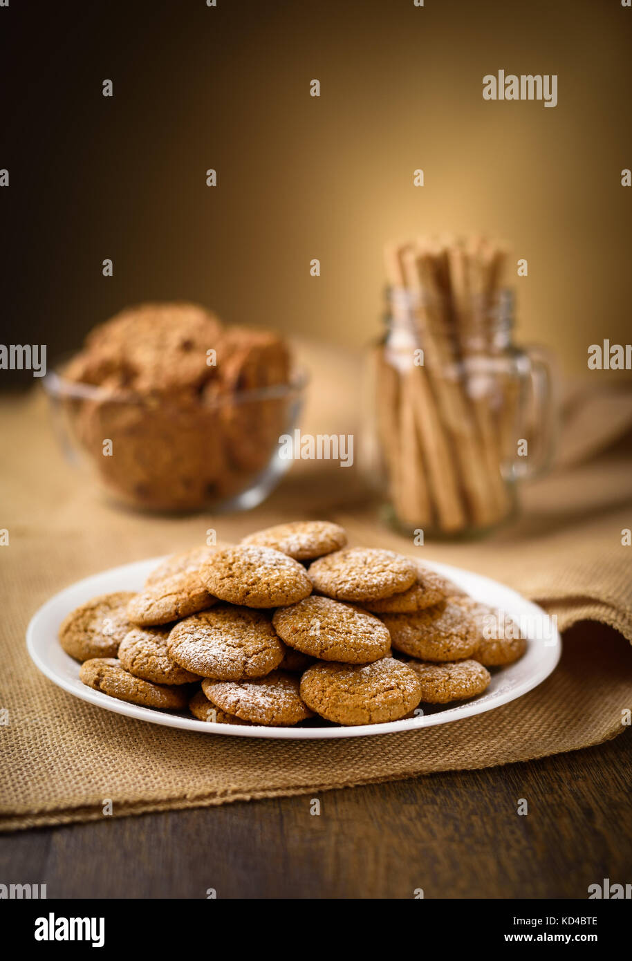 Honey ginger cookies in the foreground. Oatmeal raisin cookies and pirouette rolled wafers in