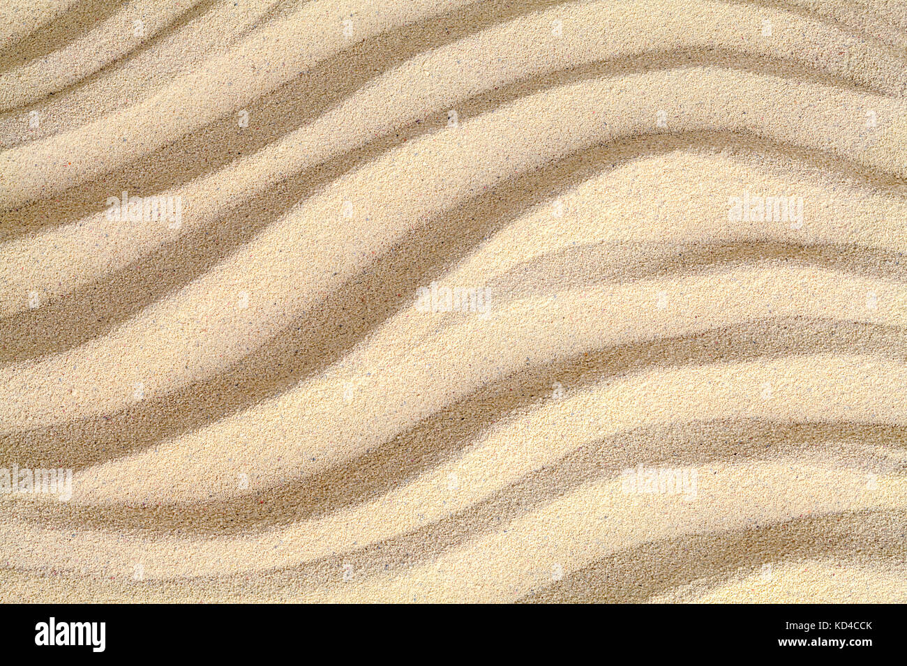 Close Up of Brown Beach Sand with Wave Pattern. Stock Photo
