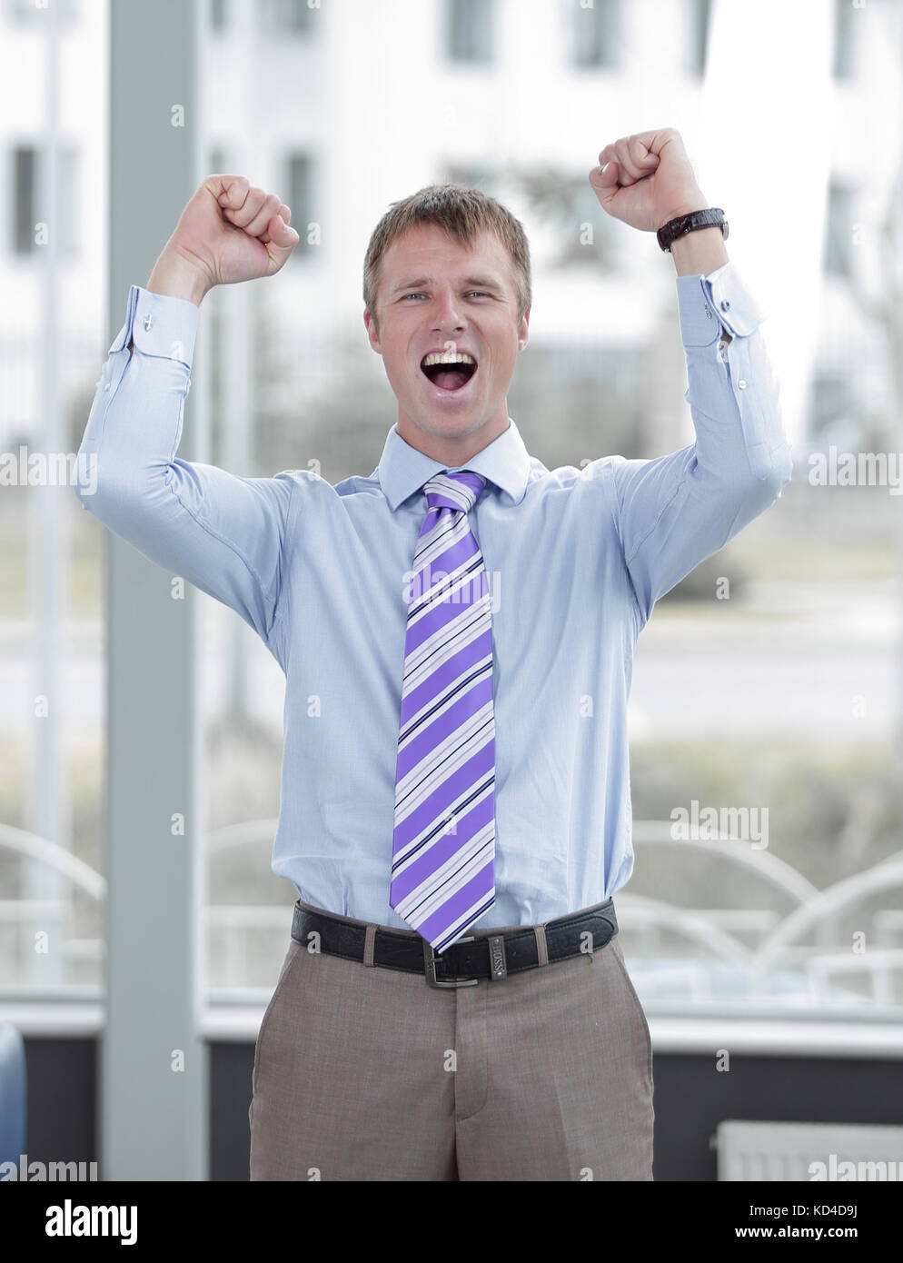 Businessman celebrating with his fists raised in the air Stock Photo ...