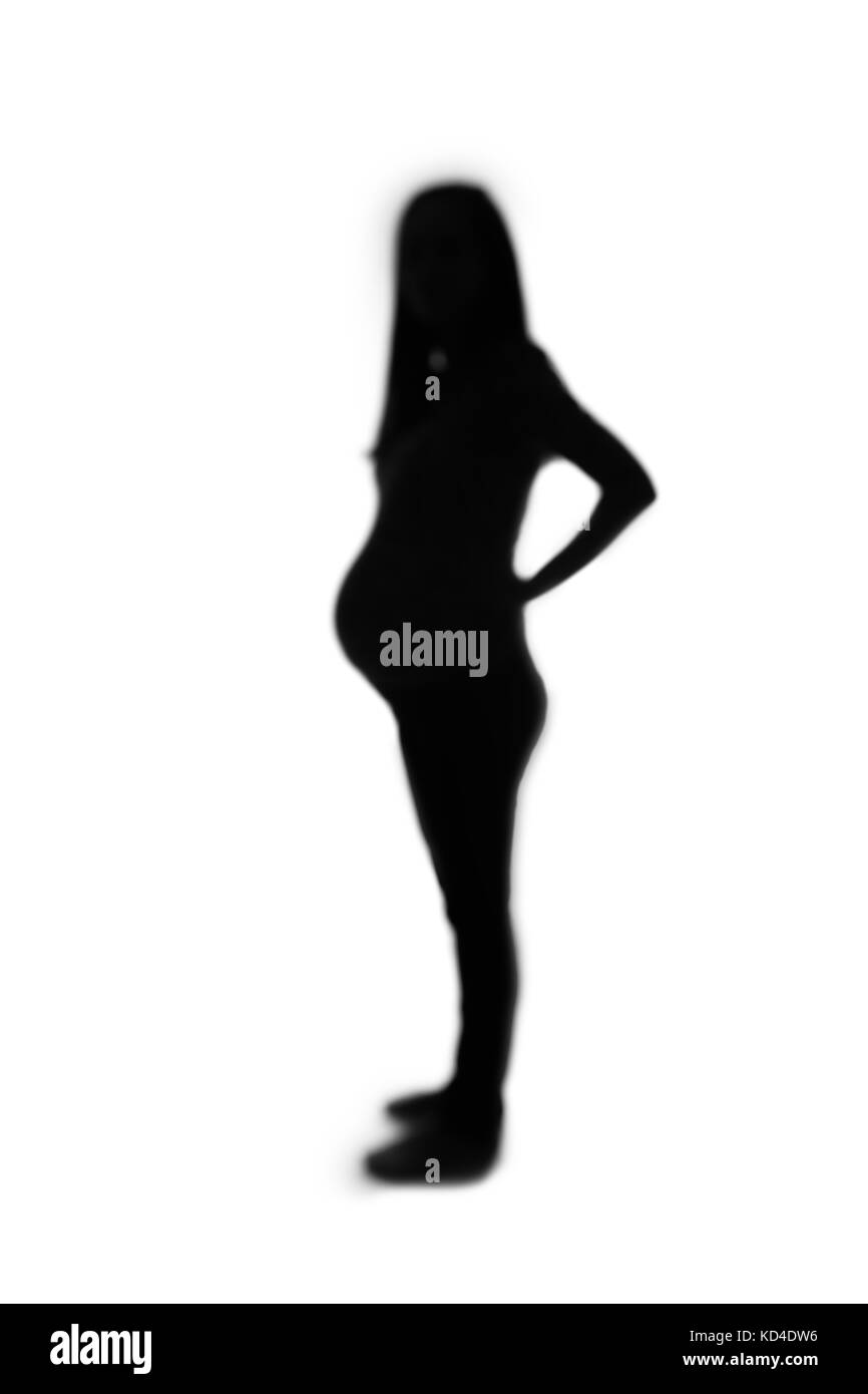 Defocused silhouette of pregnant woman isolated on white background. Stock Photo