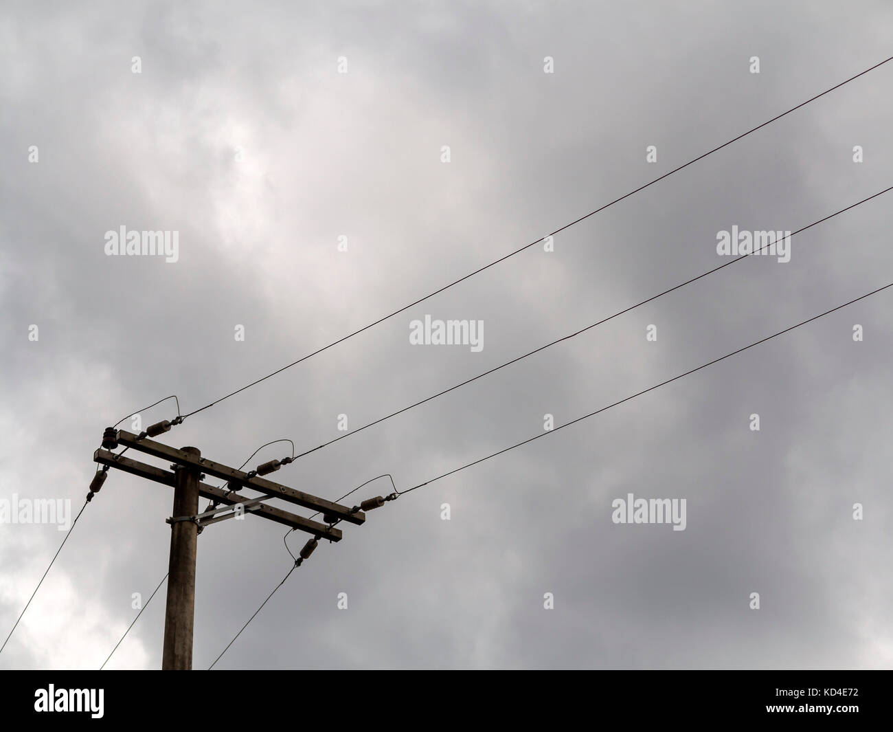 wooden electric post with wires in a gray cloudy day Stock Photo Alamy