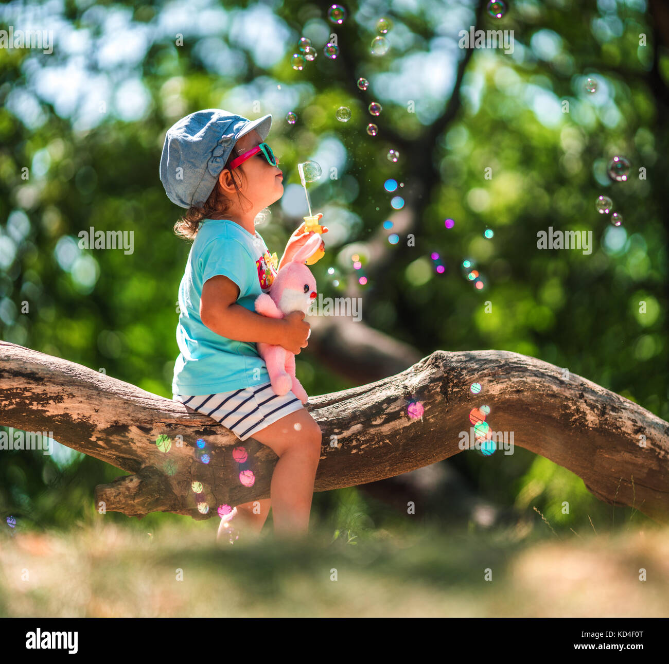One years old little girl blowing soap bubbles in summer park. Child plaiyng Stock Photo Alamy