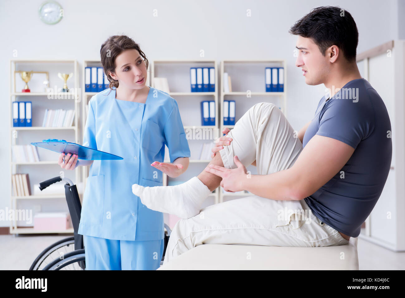 Doctor And Patient During Check Up For Injury In Hospital Stock Photo