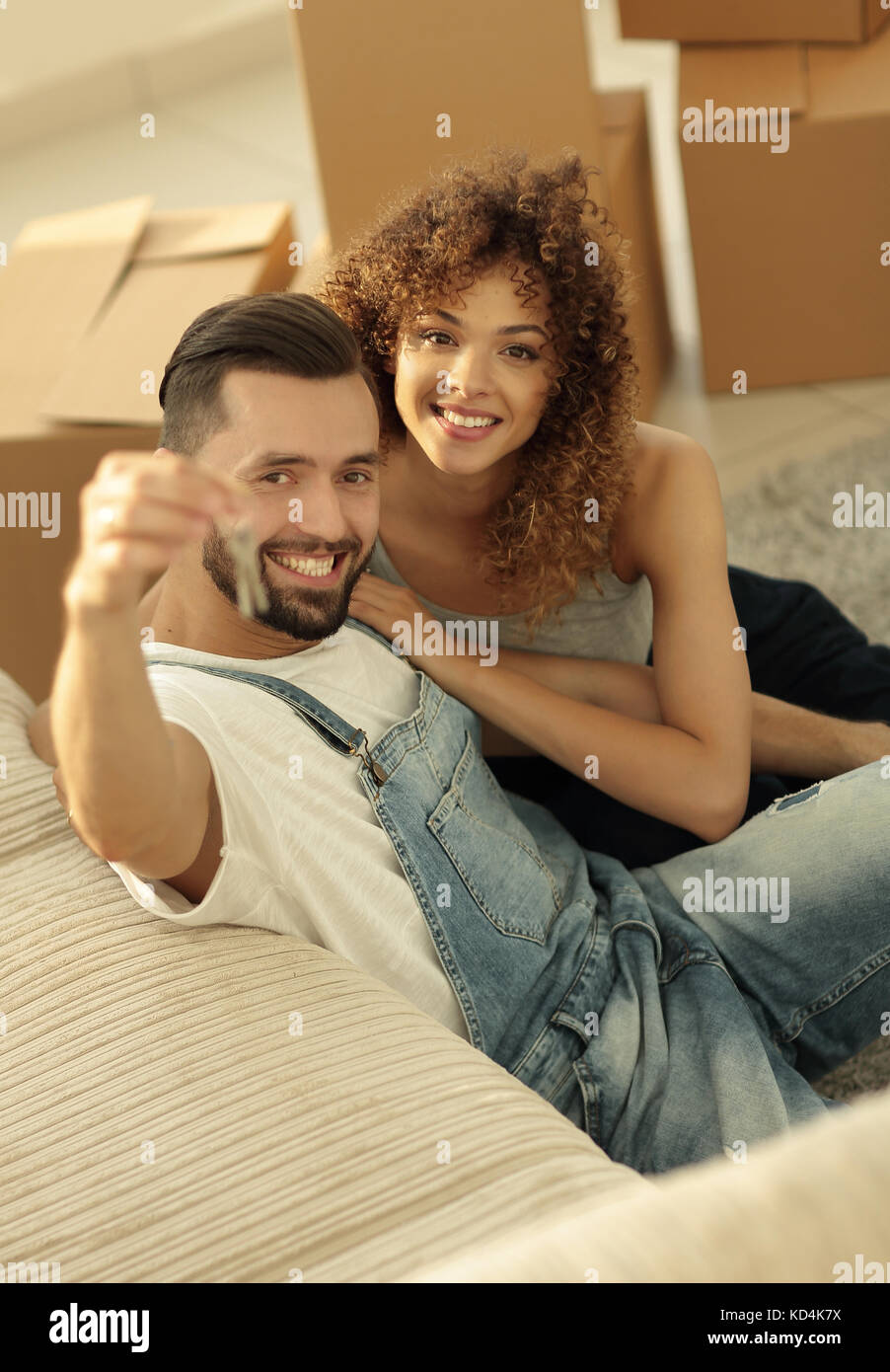 young couple holding the key to a new apartment Stock Photo - Alamy
