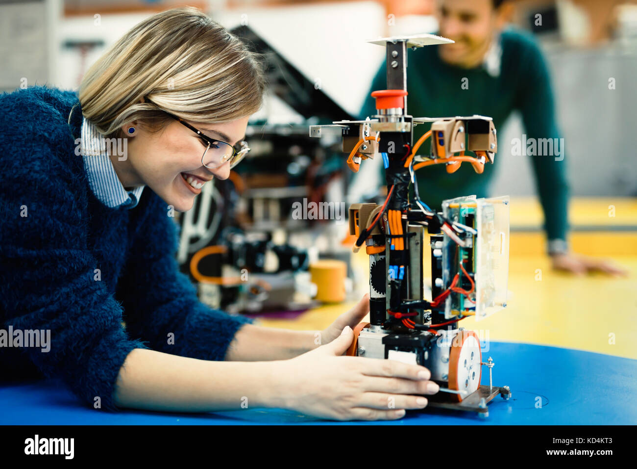 Young engineer testing her robot in workshop Stock Photo