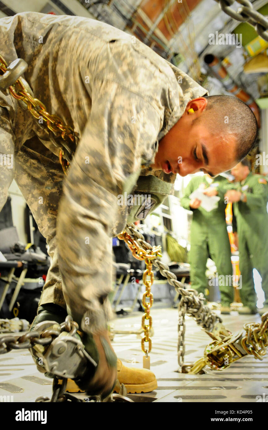 U.S. Army Sgt. Rudy Uribe, a 19K, M1 Armor Crewman, secures a M1A1SA ...