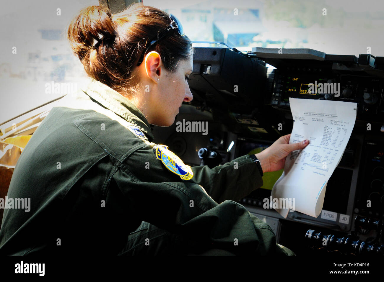 U.S. Air Force Cpt. Molly Sanford, a C-17 Pilot with the 315th Airlift Wing, prepares the aircraft before flight. The South Carolina Army National Guard’s 1-118th Combined Arms Battalion (CAB) participates in heavy airlift operations April 10-11, 2014 at Wright Army Airfield (WAAF), Hinesville, Ga., to demonstrate the joint, total force, capabilities of the S.C. Army Guard and U.S. Air Force Reserve’s 315th Airlift Wing.  Soldiers and Airmen worked in unison over two days to load and secure four of the 1-118th CAB’s new M1A1SA Abrams Main Battle Tanks onto four U.S. Air Force C-17 transport pl Stock Photo